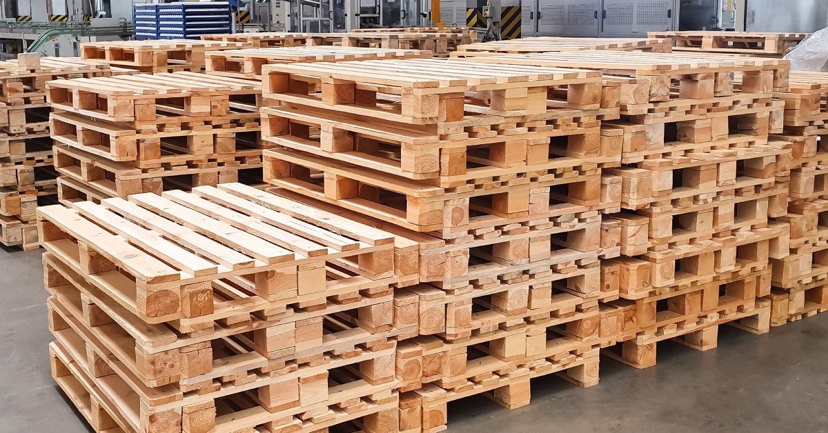Stacks of newly assembled wooden pallets in a warehouse